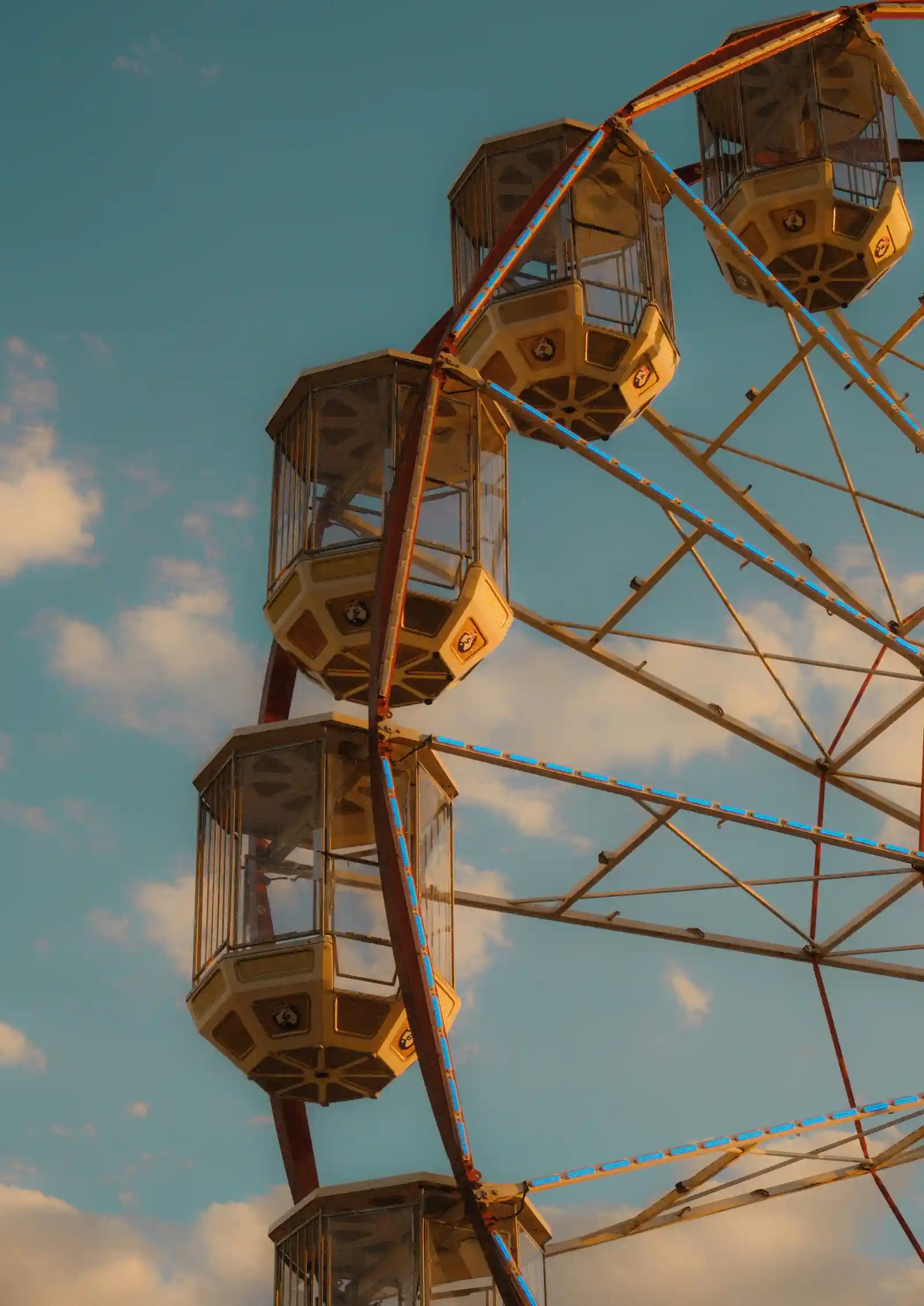 Ferris wheel against a blue sky at golden hour