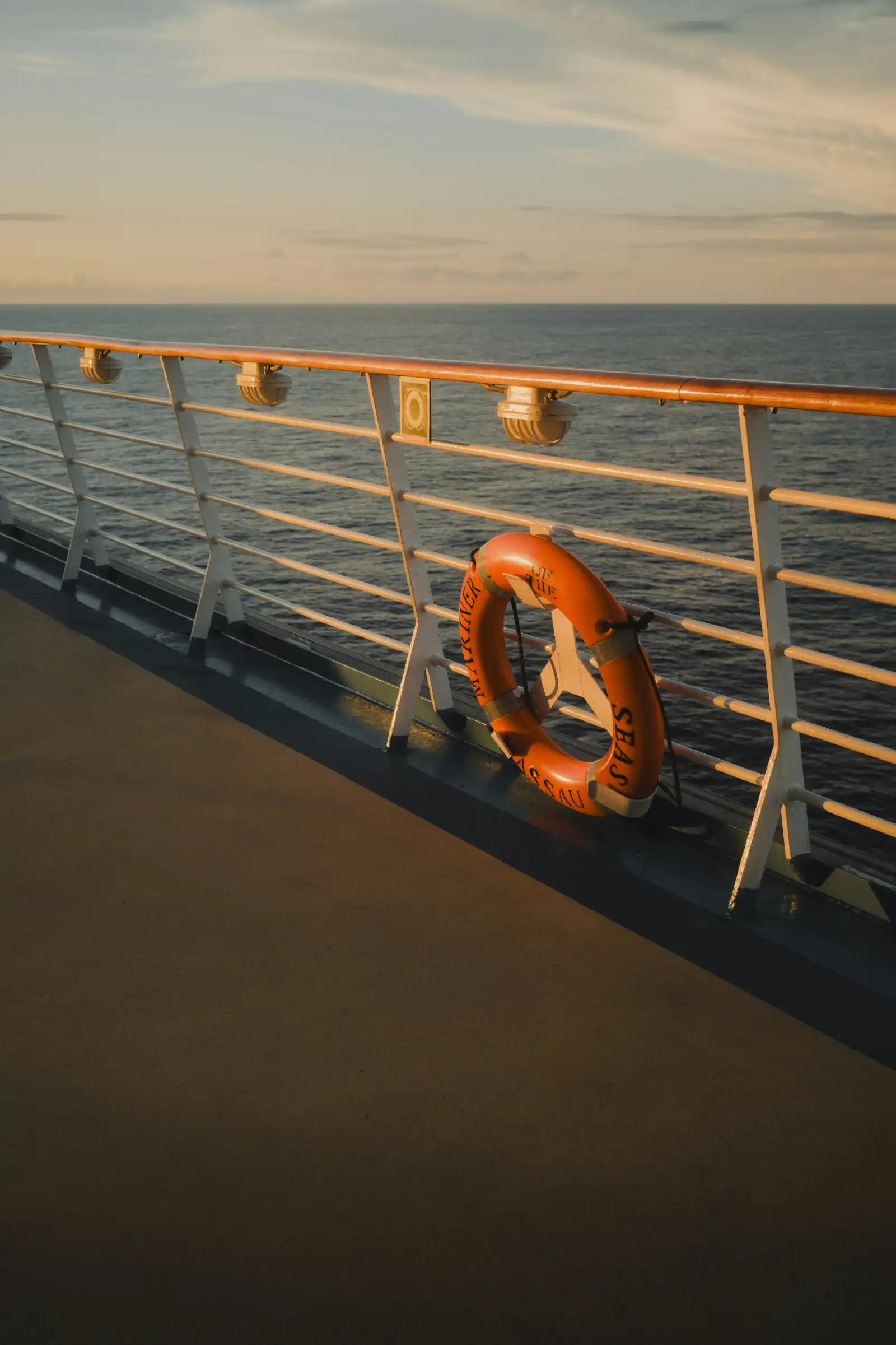 Lifebuoy on a ship railing at sunset